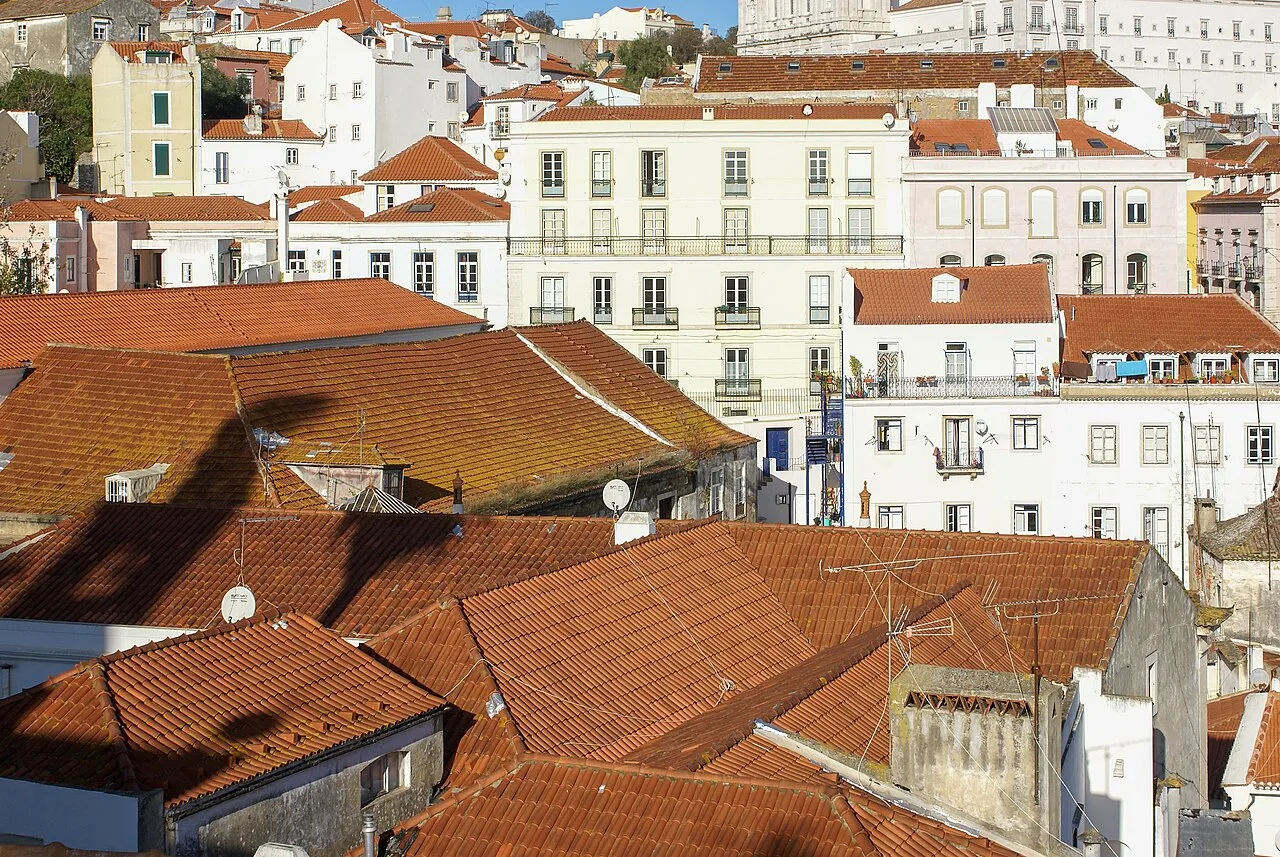 Tiled rooftops and hillside buildings in Alfama, Lisbon