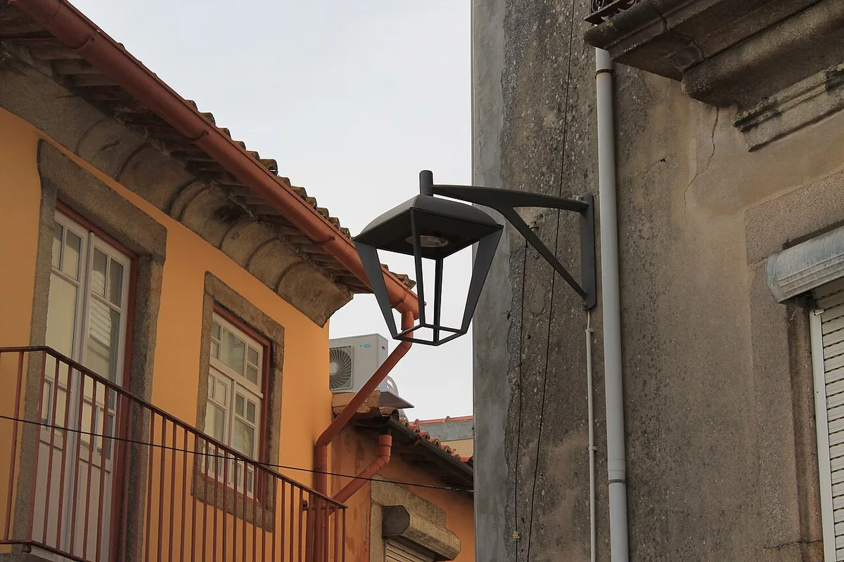 Wall-mounted street lantern beside traditional Porto houses