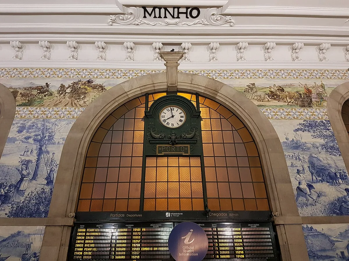 Tiled São Bento railway station hall with clock and historic departure boards