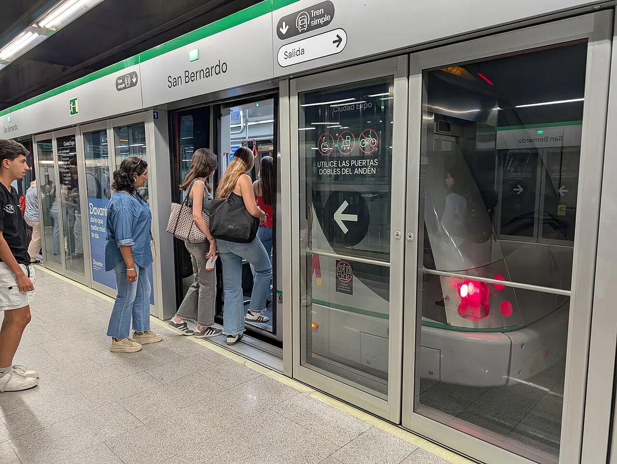 Passengers boarding a Seville Metro train at San Bernardo station