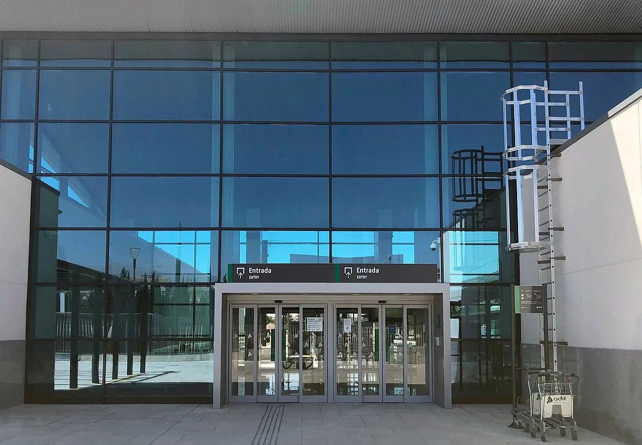 Glass-fronted entrance to Granada railway station with entry signs